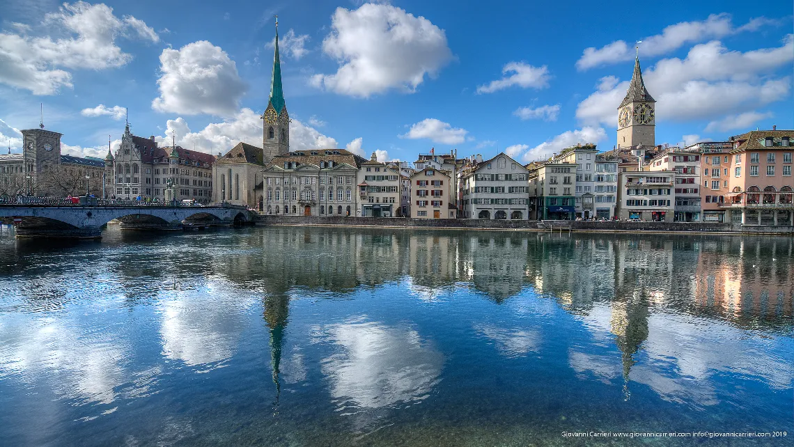 Limmat river and the clock's tower of St. Peter and Fraumüunster - Zurich